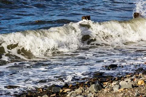 Waves crash onto a Beach Stock Photos