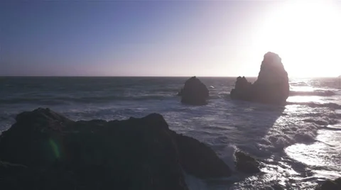Waves crash on beach at sunset- Slow Motion Stockbeeldmateriaal 39724384