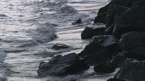 Waves crash black rocks Video stock 31387725
