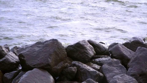 The waves crash on black rocks Stock Footage 79664271
