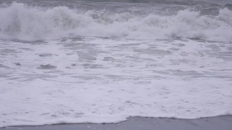 Waves crash on black sand beach in Vik, Iceland at dusk 스톡 동영상 327082574