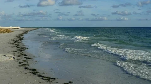 Waves crash gently on an empty beach, 4K Stock Footage 54089239