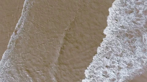 Waves crash onto golden sand Stock Footage 346261801