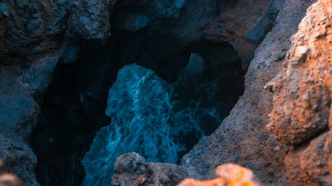 Waves crash inside a rock tunnel at Los Hervidores in Lanzarote Stock Footage 89146159