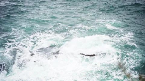 Waves crash on a large rock in the sea. Stock Footage 220153995