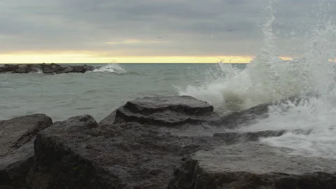 Waves crash over a breakwater Stock Footage 132584132