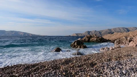 Waves crash on the Pebble Beach at Dawn in the Morning Video stock 262994578