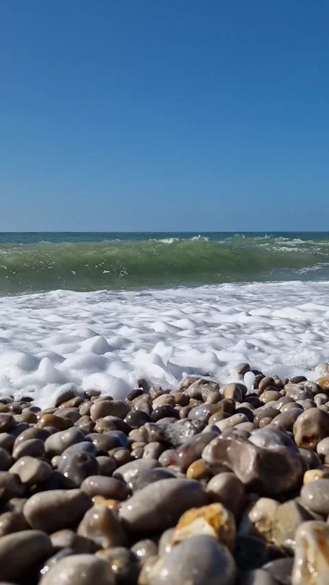 Waves Crash Pebble Beach Low Angle Shot Stock Footage 318349046