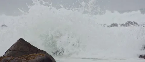 Waves crash on the rocks of the beach, steady shot Stock Footage 212460793