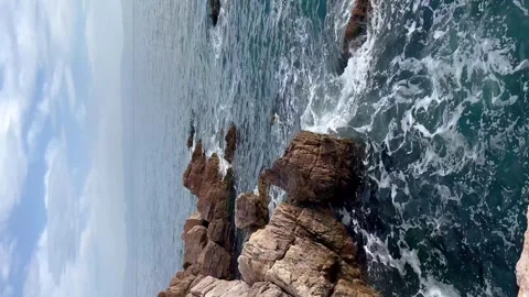 Waves crash on rocks cliffs - Vertical stock video Stock Footage 240326600