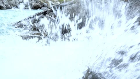 Waves crash onto rocks in close-up Stock Footage 94598637
