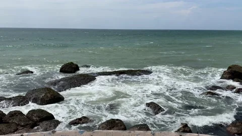 Waves crash on rocks cost, Big waves breaking on the shore with sea foam Stock Footage 164872070
