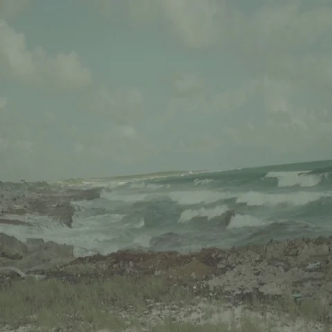 Waves Crash on Rocky Beach During Storm Stock Footage 69699567