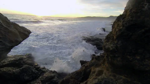 Waves crash on a rocky beach at sunset 스톡 동영상 36143166