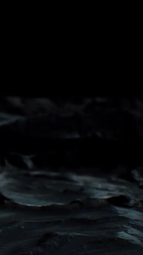 Waves crash on rocky shore during nighttime with dark sky and water Stock Footage 344959355