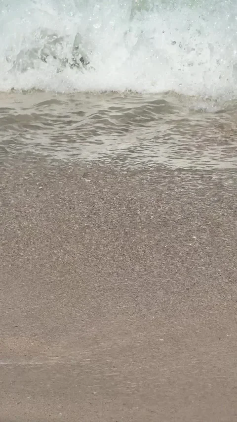 Waves crash onto a sandy beach. Close-up view. Stock Footage 282800002