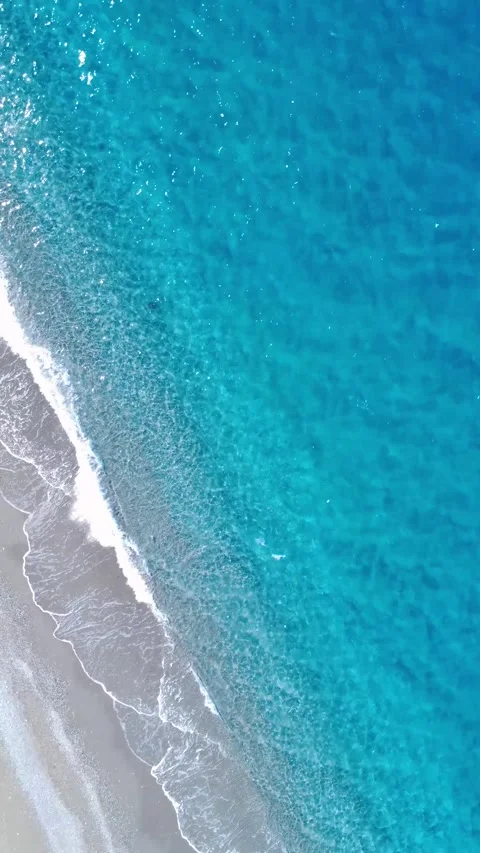 Waves Crash on Sandy Beach During Sunny Day With Clear Blue Water in Tropical Stock Footage 322936165