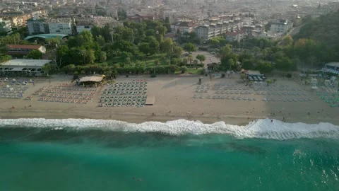 Waves crash on the sandy shore of the beach. Top view of the beach with sun Stock-Footage 162664436
