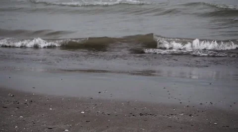 Waves crash on sandy shore (close up) Video stock 57873644