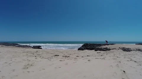 Waves crash onto shore at beach Stock Footage 58905065