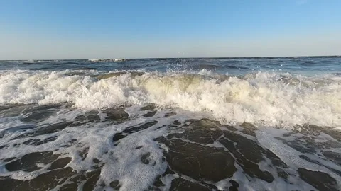 Waves crash into the shore in a spray during a small storm Stock Footage 263119443