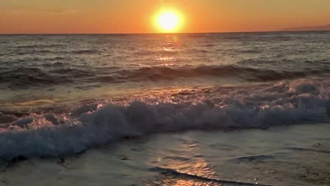 Waves Crash on Shore as Sun Sets Over the Ocean in California Stock Footage 330794765
