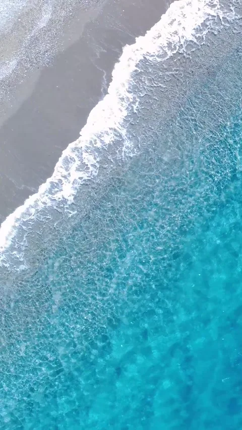 Waves Crash on Shore at a Tropical Beach During Daylight in a Sunny Coastal Stock Footage 322936084