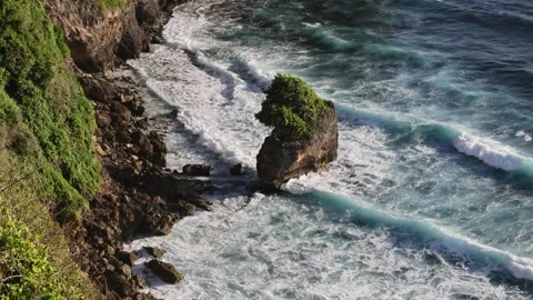 Waves crash on a small stone island. Stock Footage 274639988