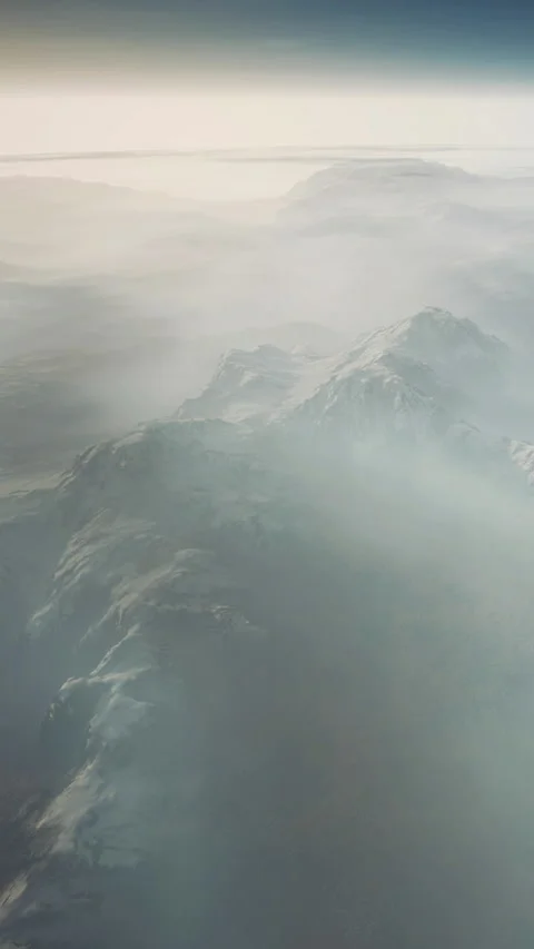 Waves crash softly against rocky shore under light clouds and mist Stock Footage 345010839