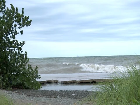 Waves crash-spray onto beach-stormy windy-wild shot Stock Footage 38707877