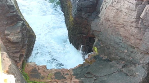 Waves crash into Thunder Hole Stock Footage 49704941