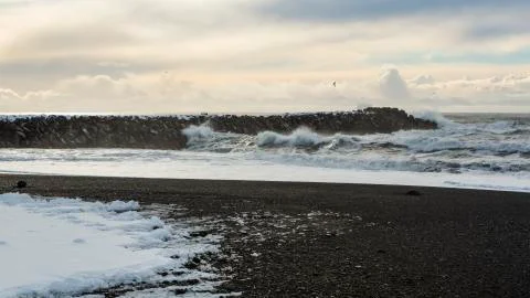 Waves crash on Vík  jetty Stock Photos