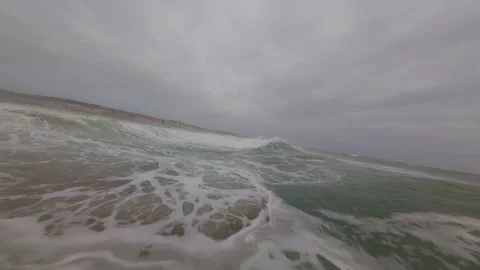 Waves crash violently under gray skies Stock Footage 345051292