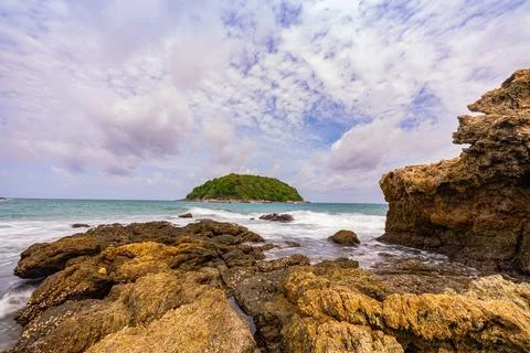 The waves crashed against the rocks. Stock Photos