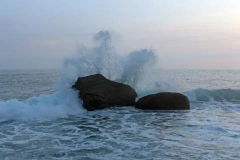 Waves crashed against the rocks in the seashore. Beautiful landscape of a beach  Stock Photos
