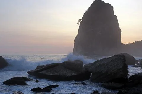Waves crashed against the rocks in the seashore. Beautiful landscape of a beach  Stock Photos