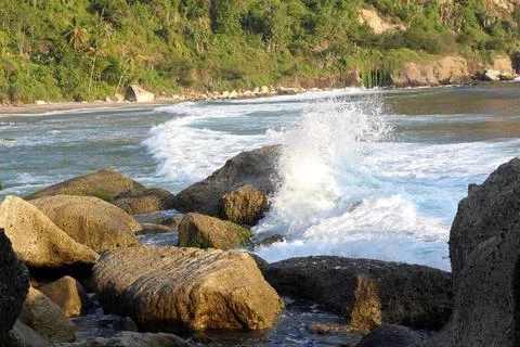 Waves crashed against the rocks in the seashore. Beautiful landscape of a b.. Stock Photos