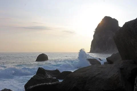 Waves crashed against the rocks in the seashore. Beautiful landscape of a b.. Stock Photos