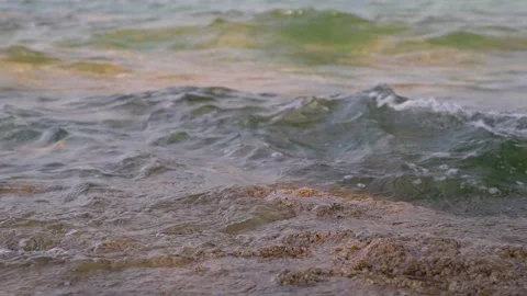 The waves crashed against the shore and crashed over the rugged rocks Stock Footage 303044577