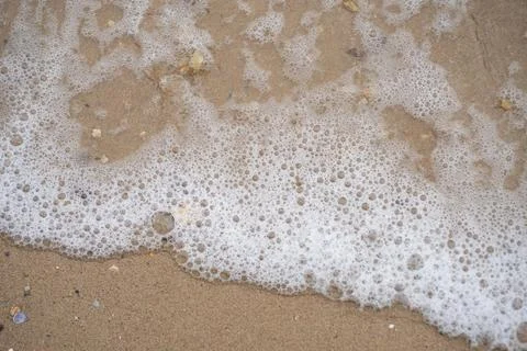 Waves crashes at the beach Stock Photos