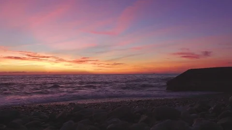 Waves crashes on breakwater at sunset over Black sea Stock Footage 79090532