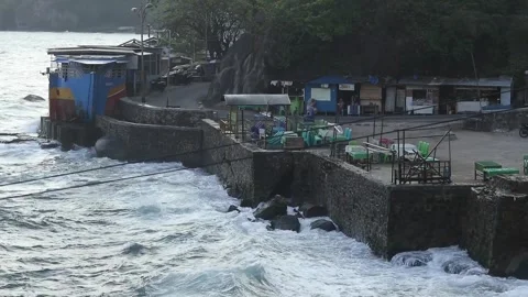 Waves crashing against the beach wall Stock Footage 252628476