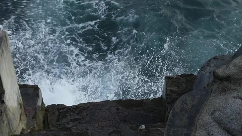 Waves crashing against the beach wall Stock Footage 252628489