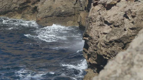 Waves crashing against the cliffs and creating a water explosion. Shot in Stock Footage 143940526