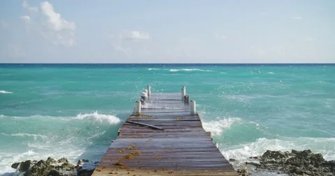 Waves crashing against a dock in the Caribbean Stock Footage 80272222