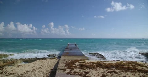 Waves crashing against a dock in the Caribbean Stock Footage 80273078