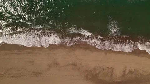 Waves crashing against an empty sand beach Stock Footage 162044187
