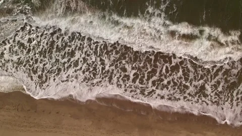 Waves crashing against an empty sand beach Stock Footage 162045058