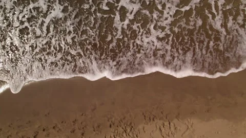 Waves crashing against an empty sand beach Stock Footage 162045231