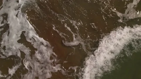Waves crashing against an empty sand beach Video stock 162045473